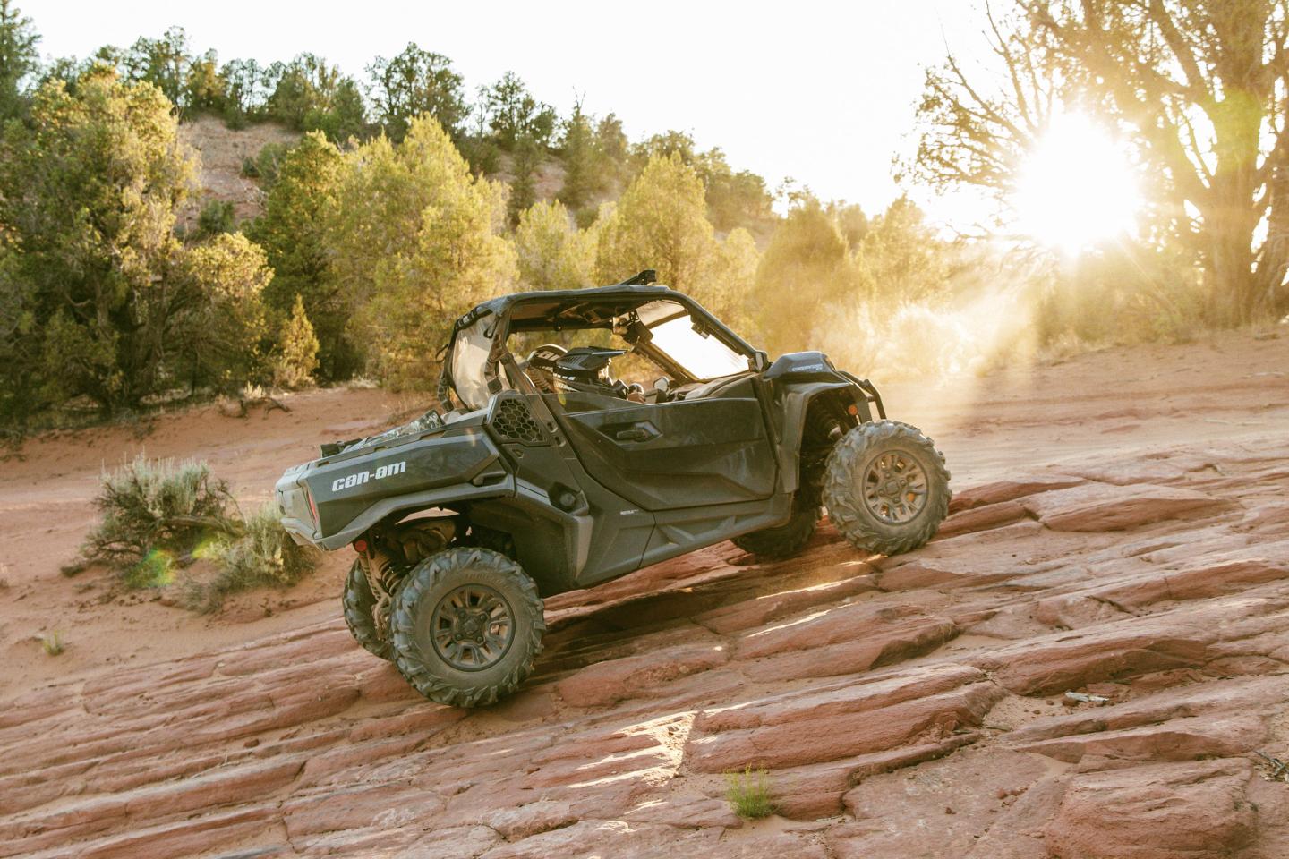 An ATV driving up some rocky ground