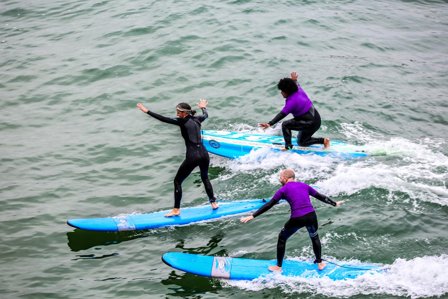 Three people surfing