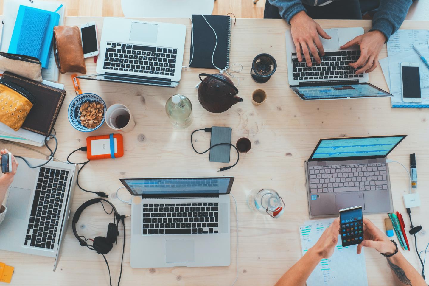 A top down view of a table with laptops