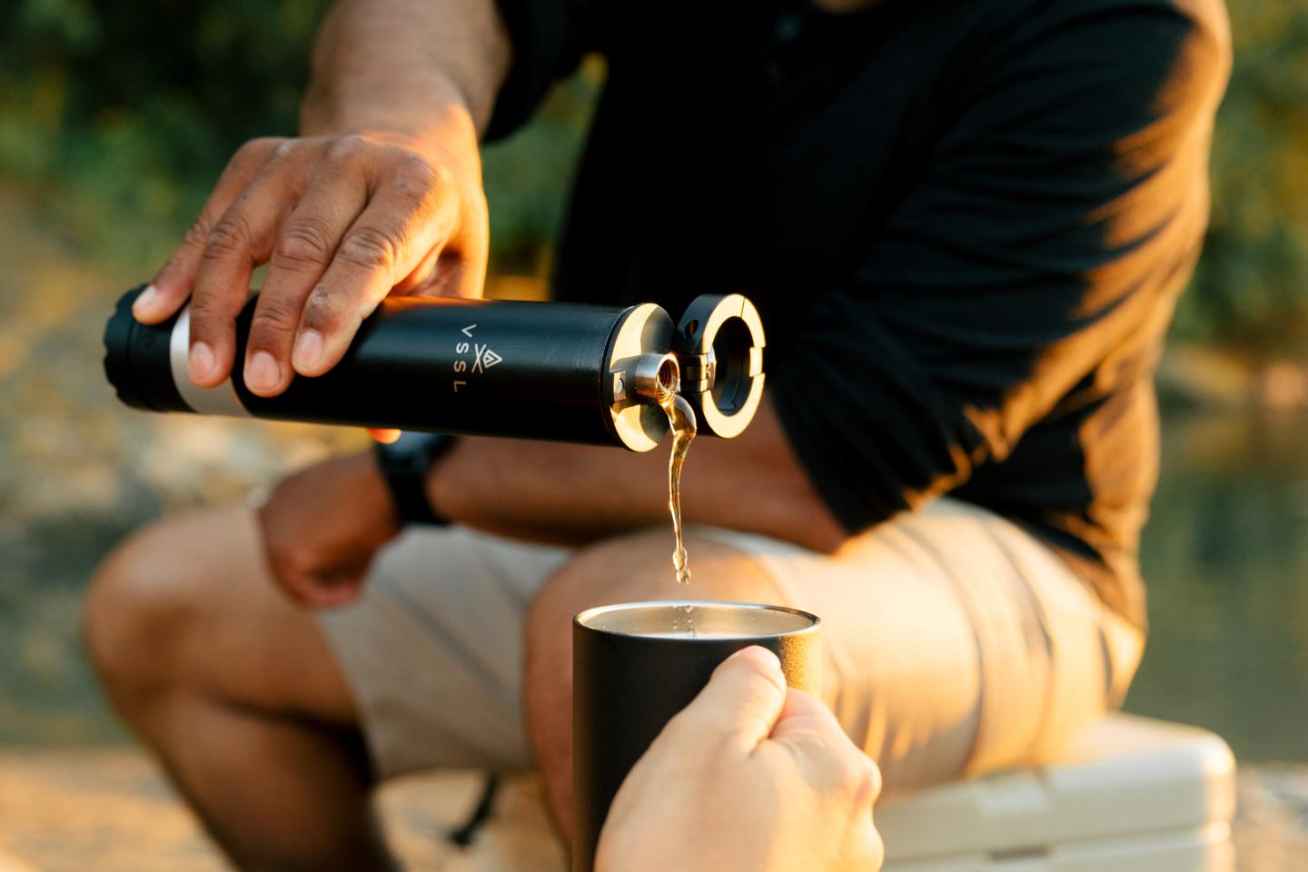 A person pouring from a VSSL flask