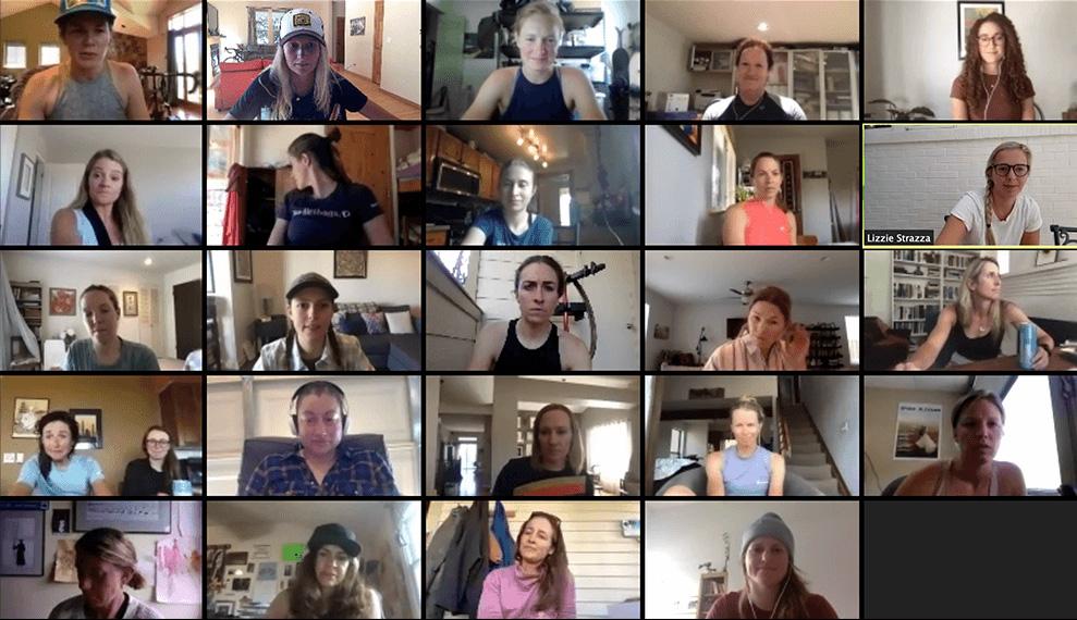 A laptop showing numerous people on a video call