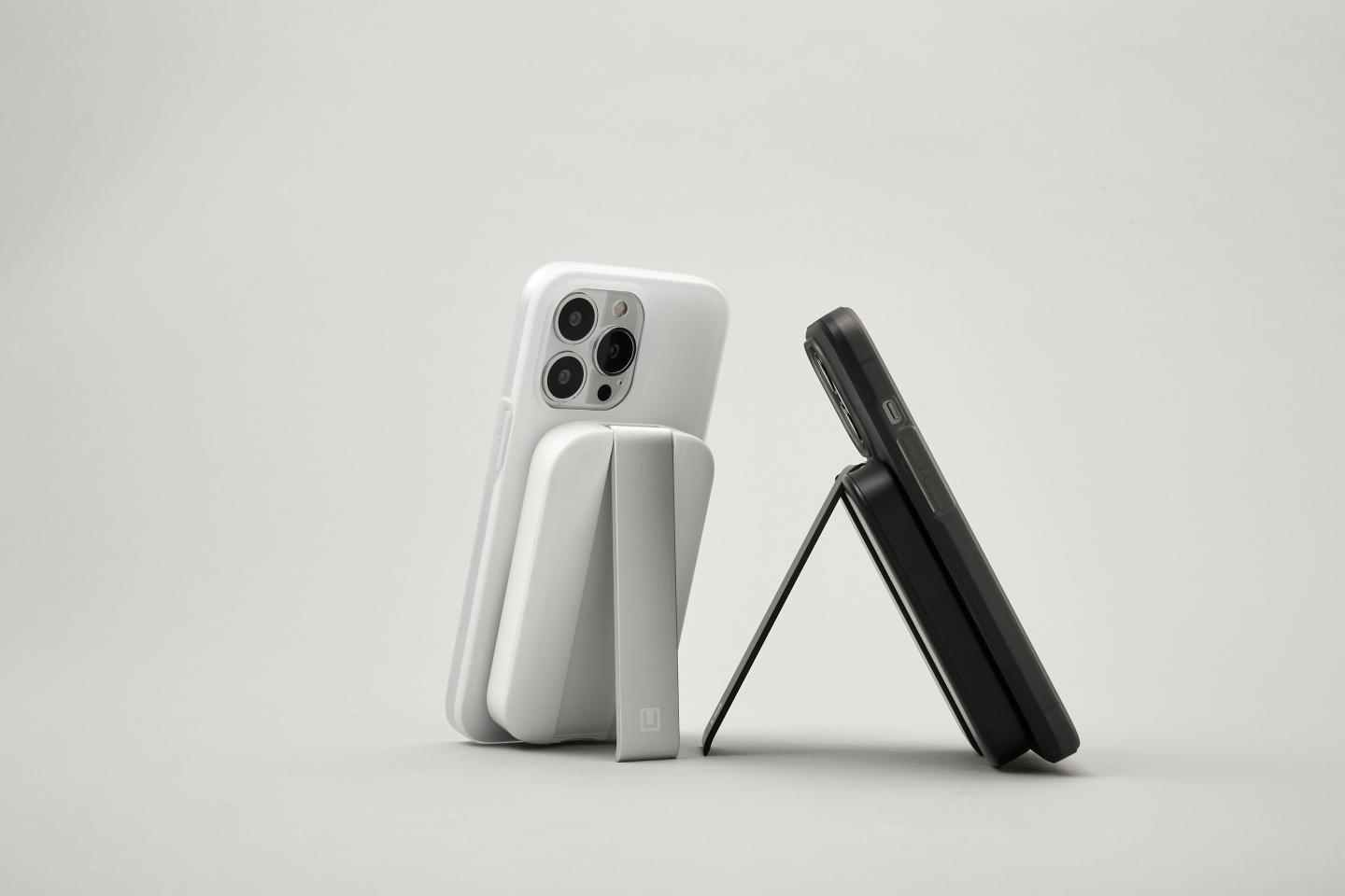 Two phones leaning on UAG kickstands