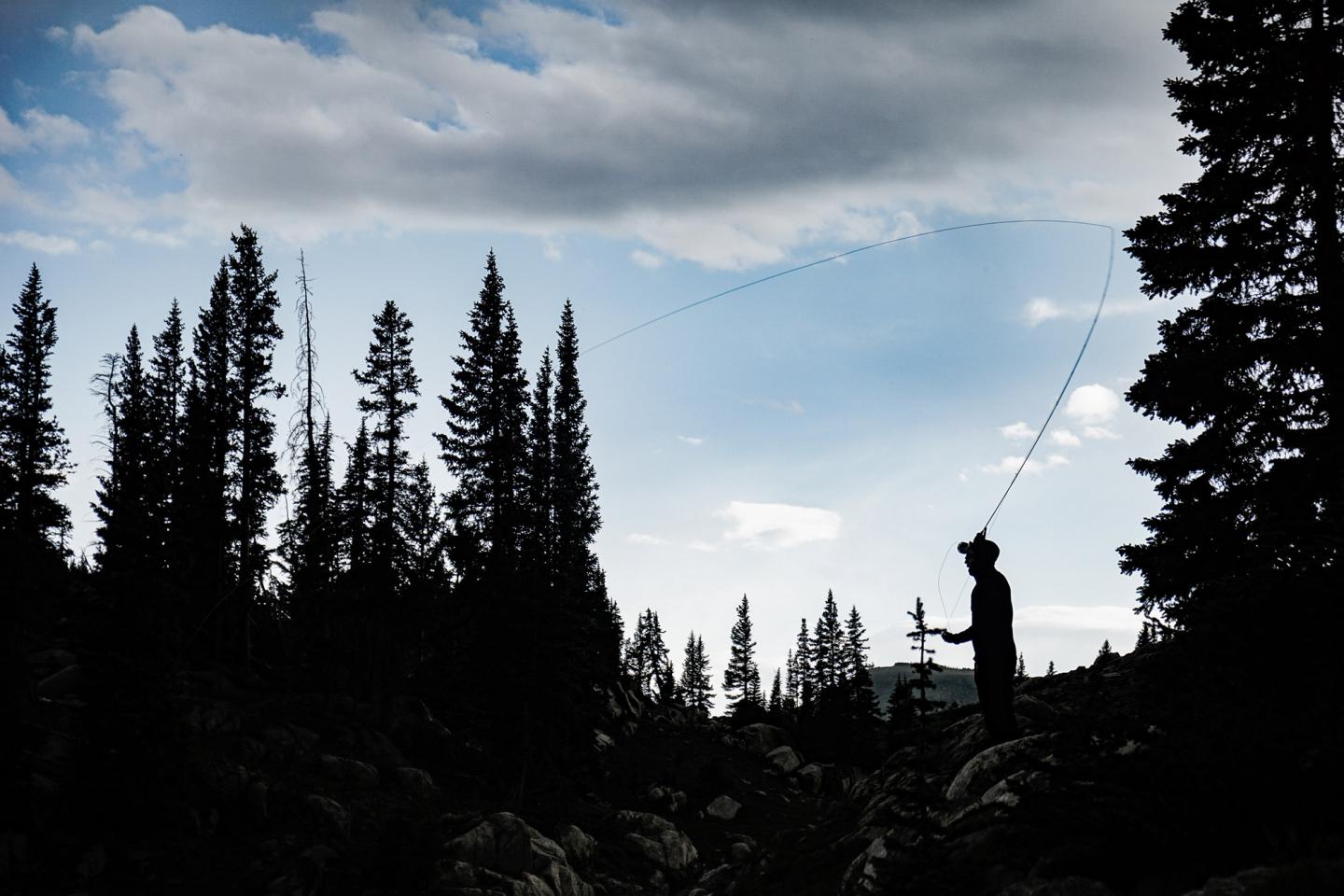 silhouette of fly fisherman
