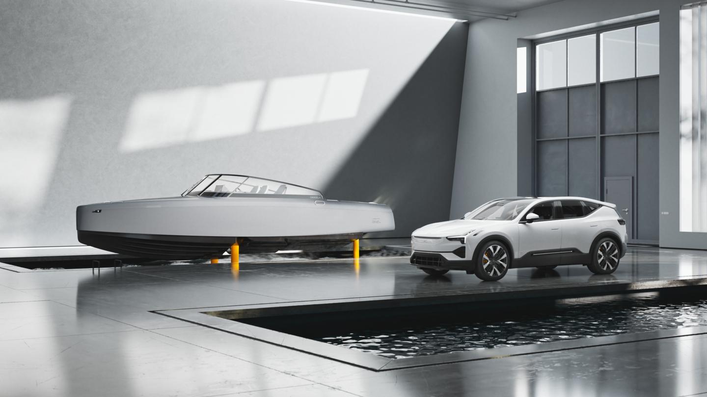 Candela C-8 Polestar Edition electric hydrofoil boat flying in a river pool next to a parked Polestar 2 electric car