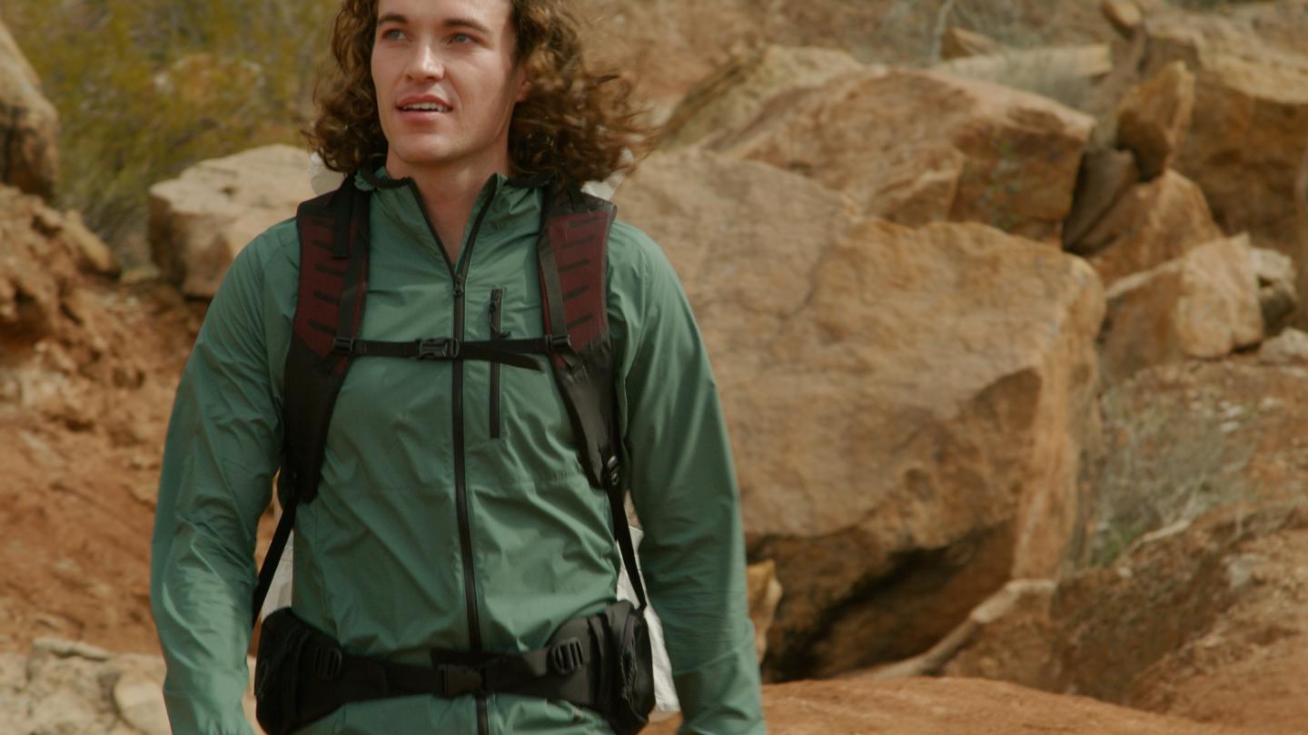 man hiking in green jacket