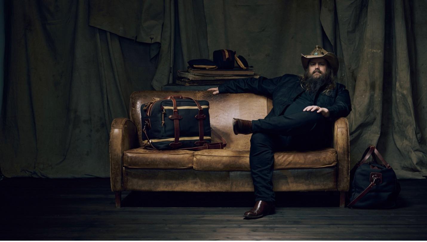 Musician Chris Stapleton posing with Filson bag collection