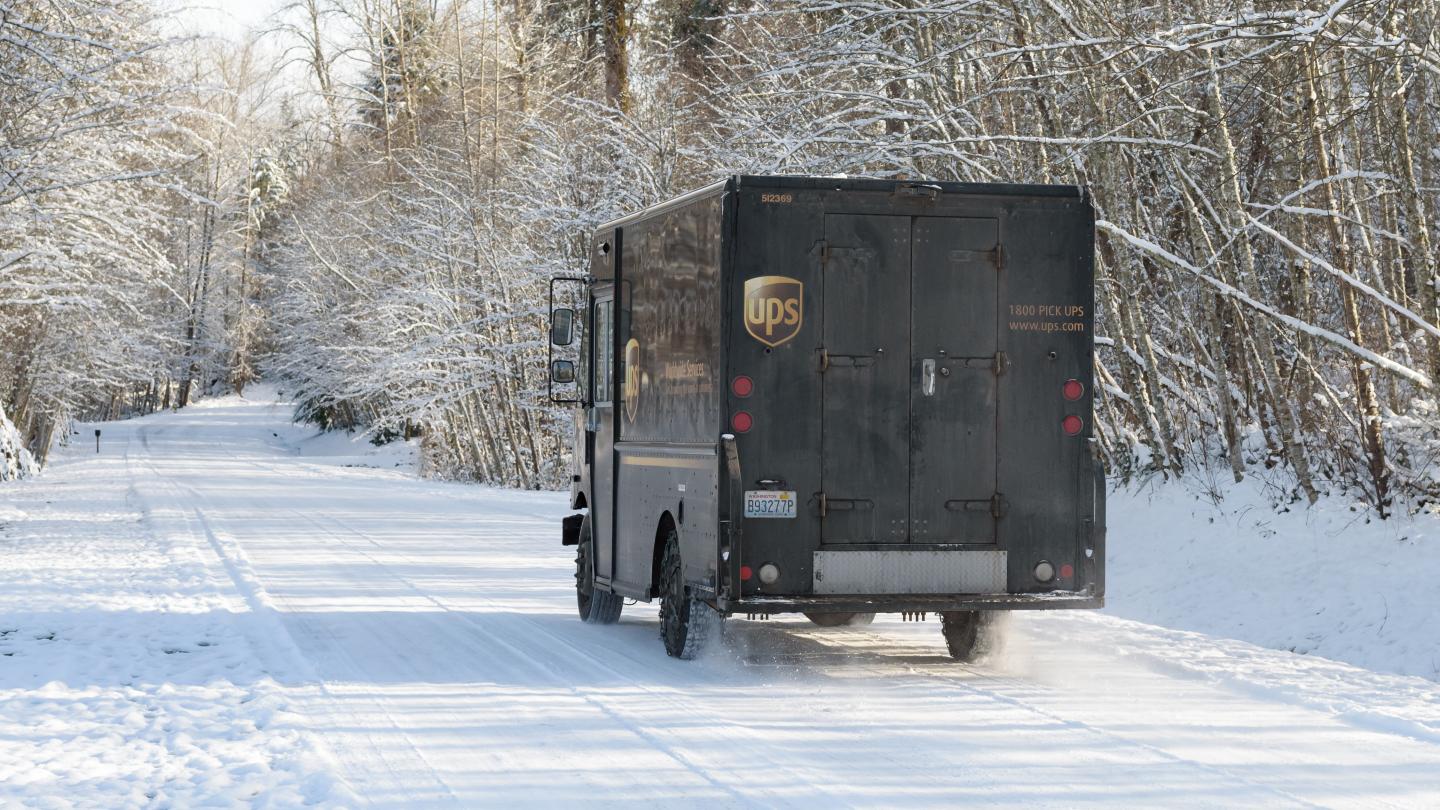 UPS truck driving in the snow
