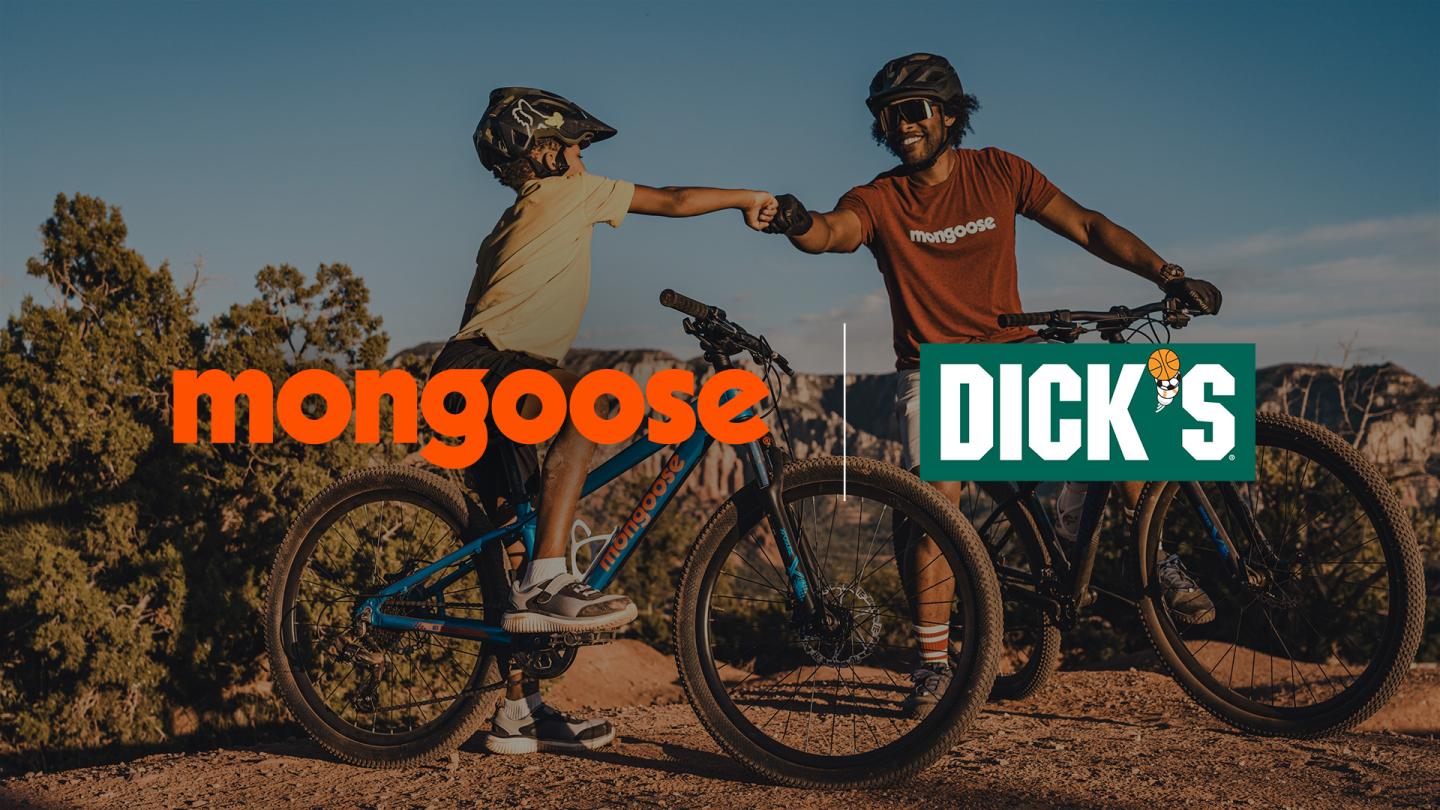 Father and son fist bumping on a mountain bike ride with Mongoose Bikes and Dicks Sporting Goods logos overlaid