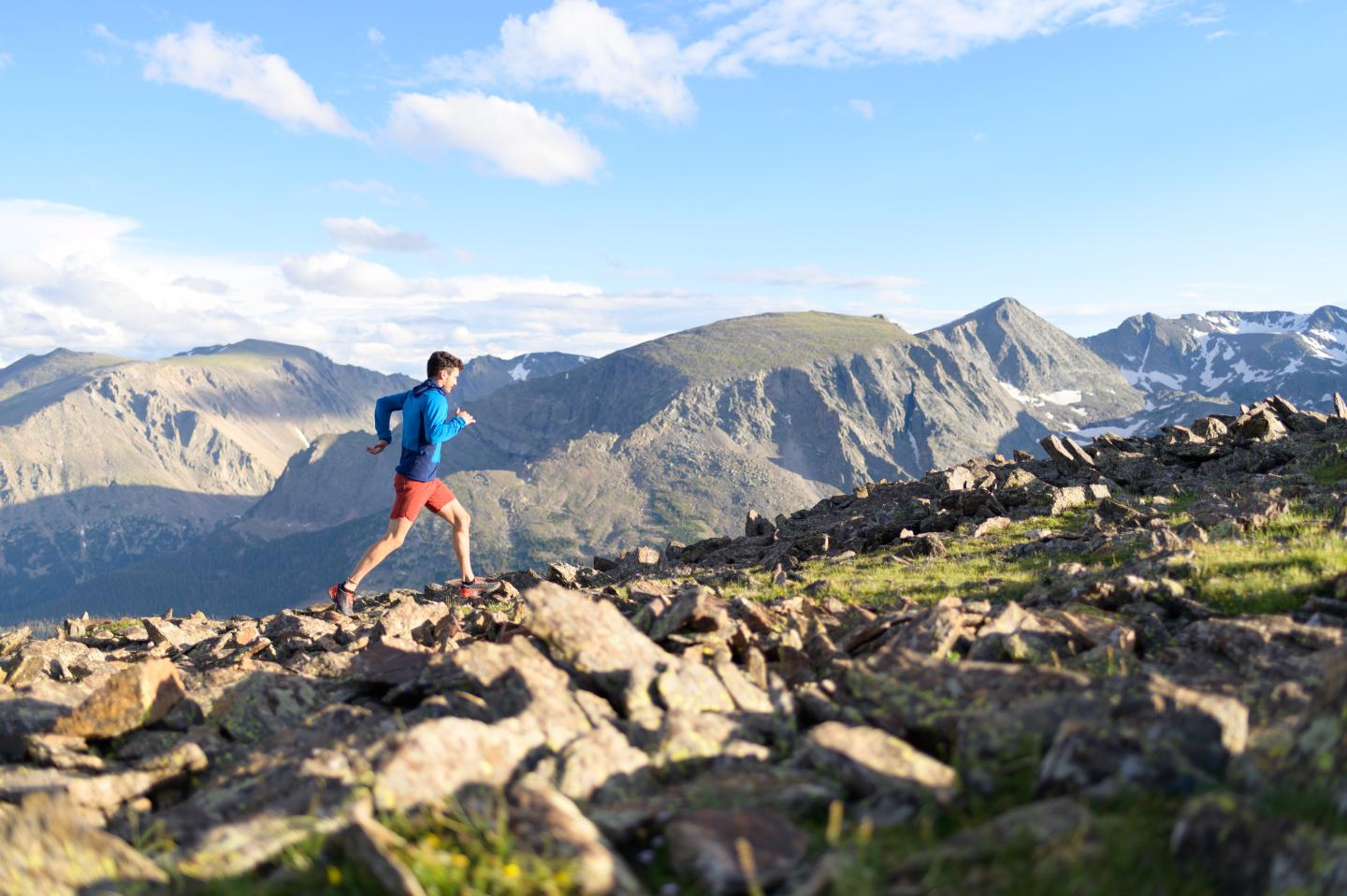 Man runs along an alpine ridgeline