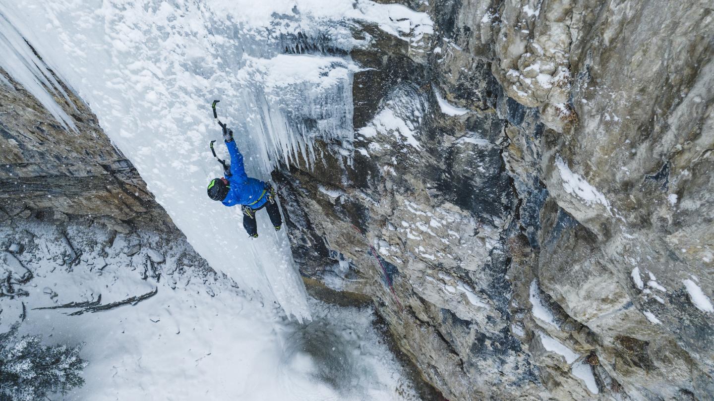 Man climbing frozen waterfall