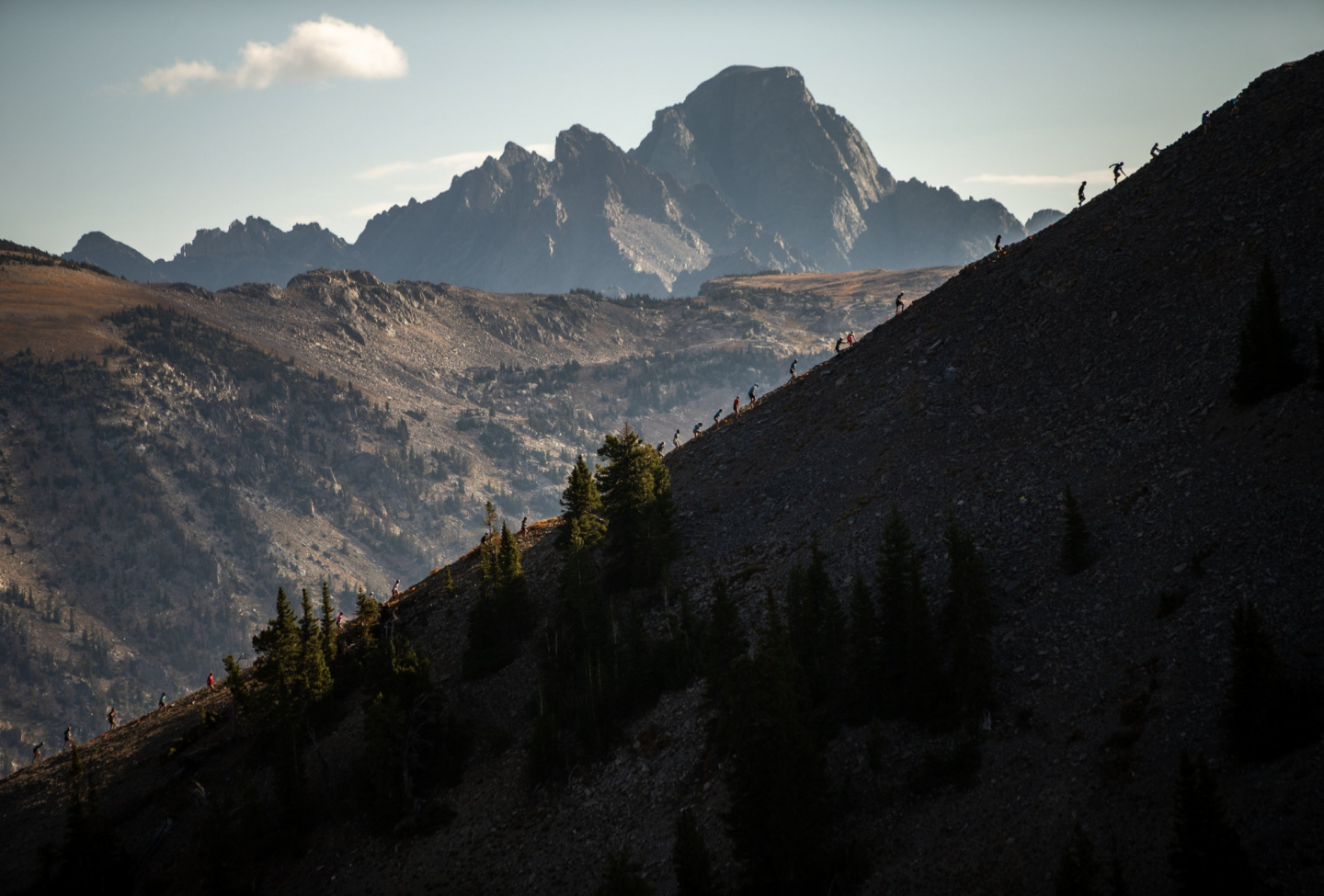 Runners silhouettes on a mountainside