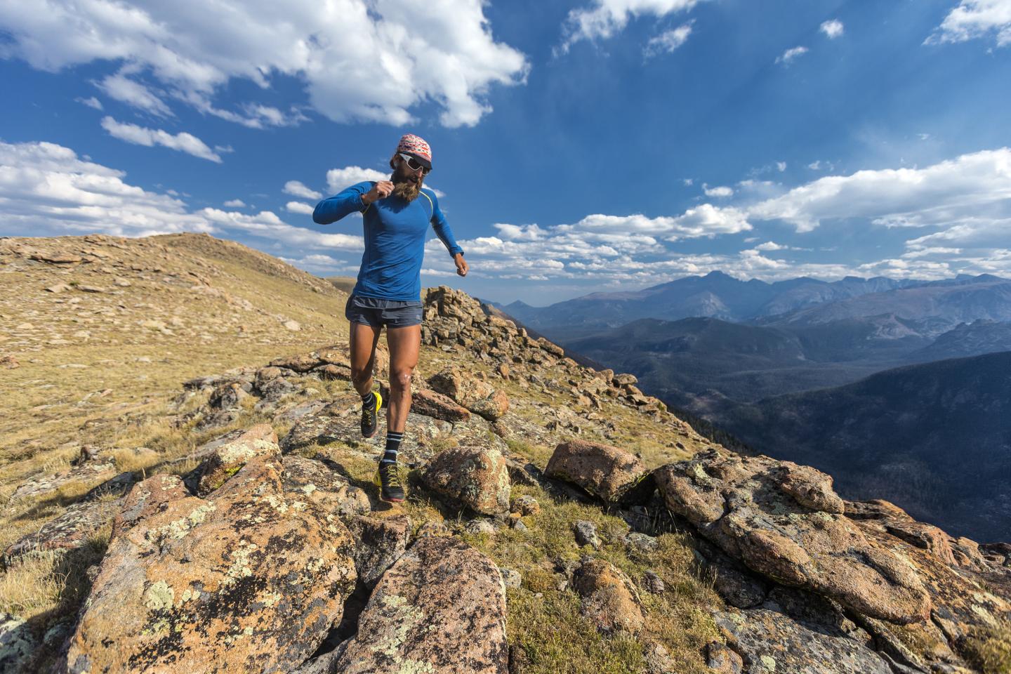 Man runs along an alpine ridgeline