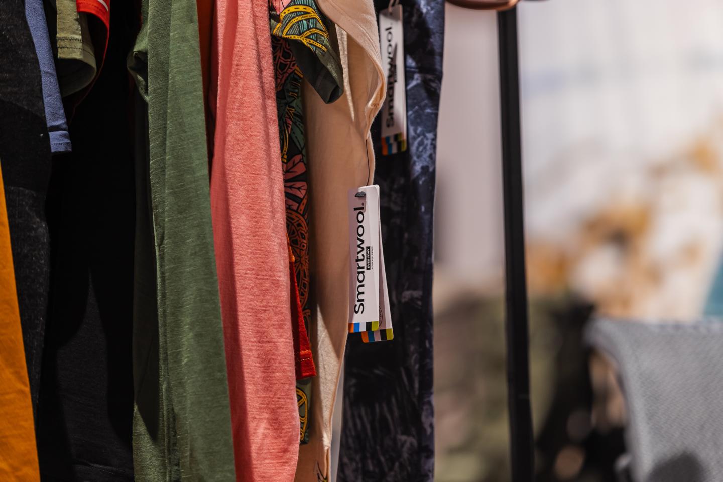 Colored clothes hanging on a rack, with focus on tags.