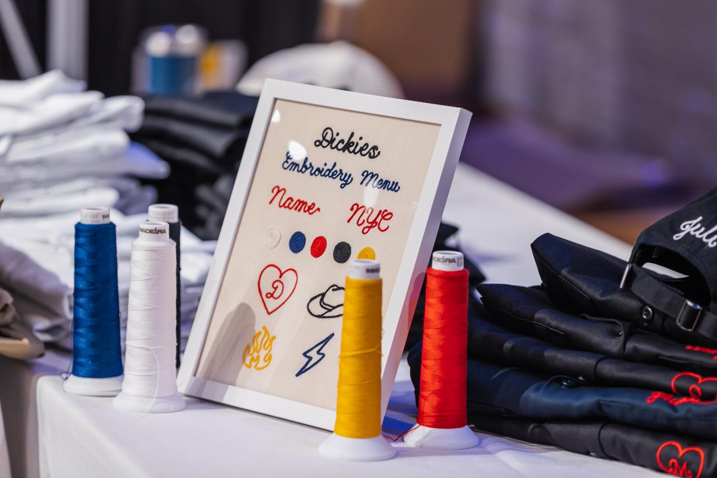 Embroidery thread display with framed color options on a table.