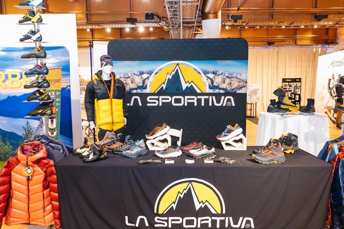 Outdoor gear display with La Sportiva branding and various shoes.