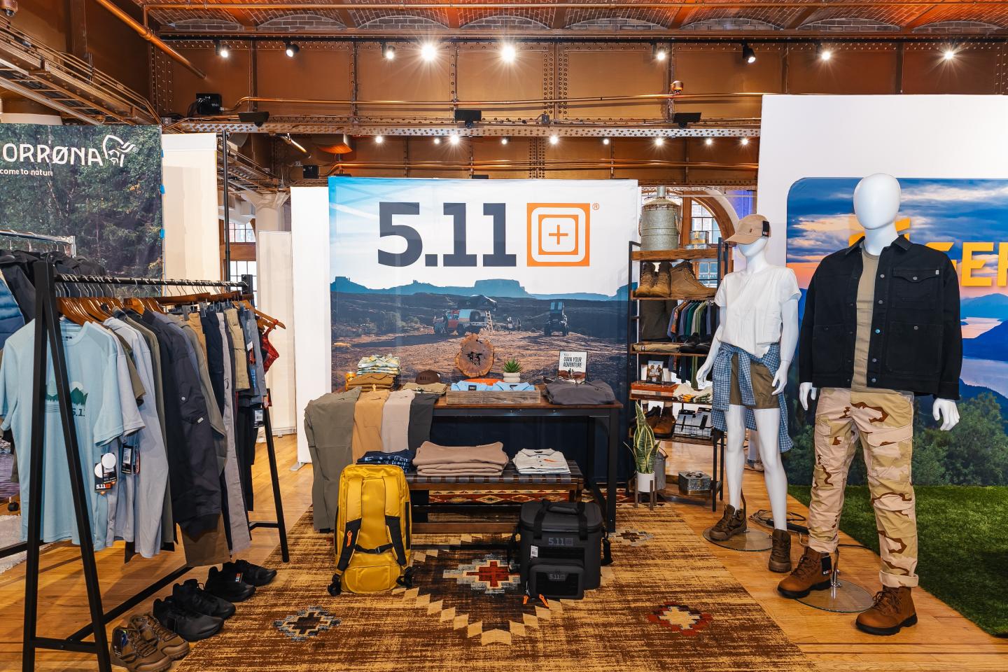 Clothing store display with mannequins, racks, and accessories.