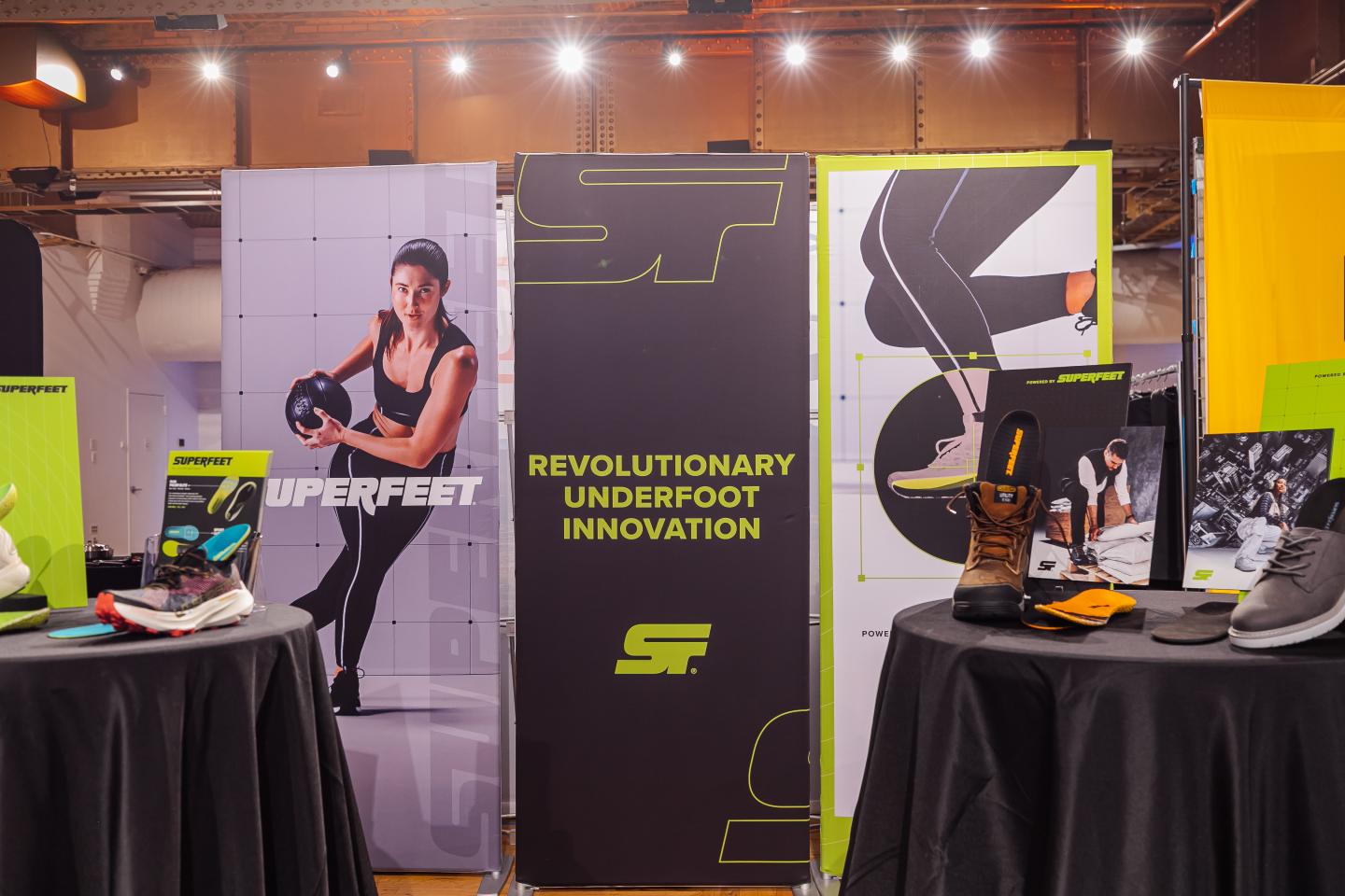 Exhibition booth with shoe displays and promotional banners.