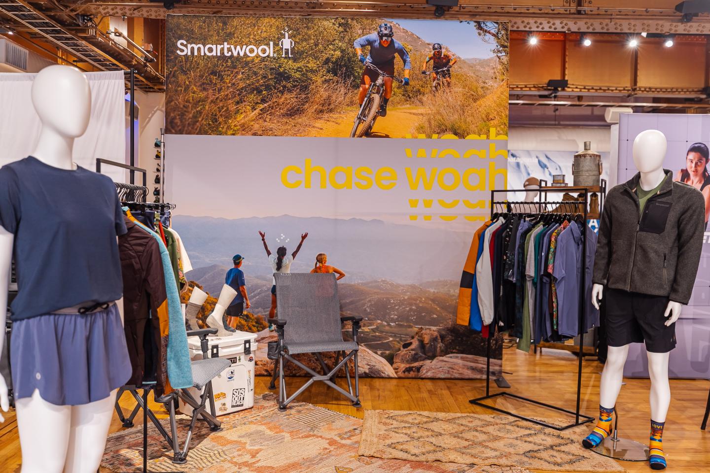 Mannequins and clothing racks in an outdoor-themed retail display.