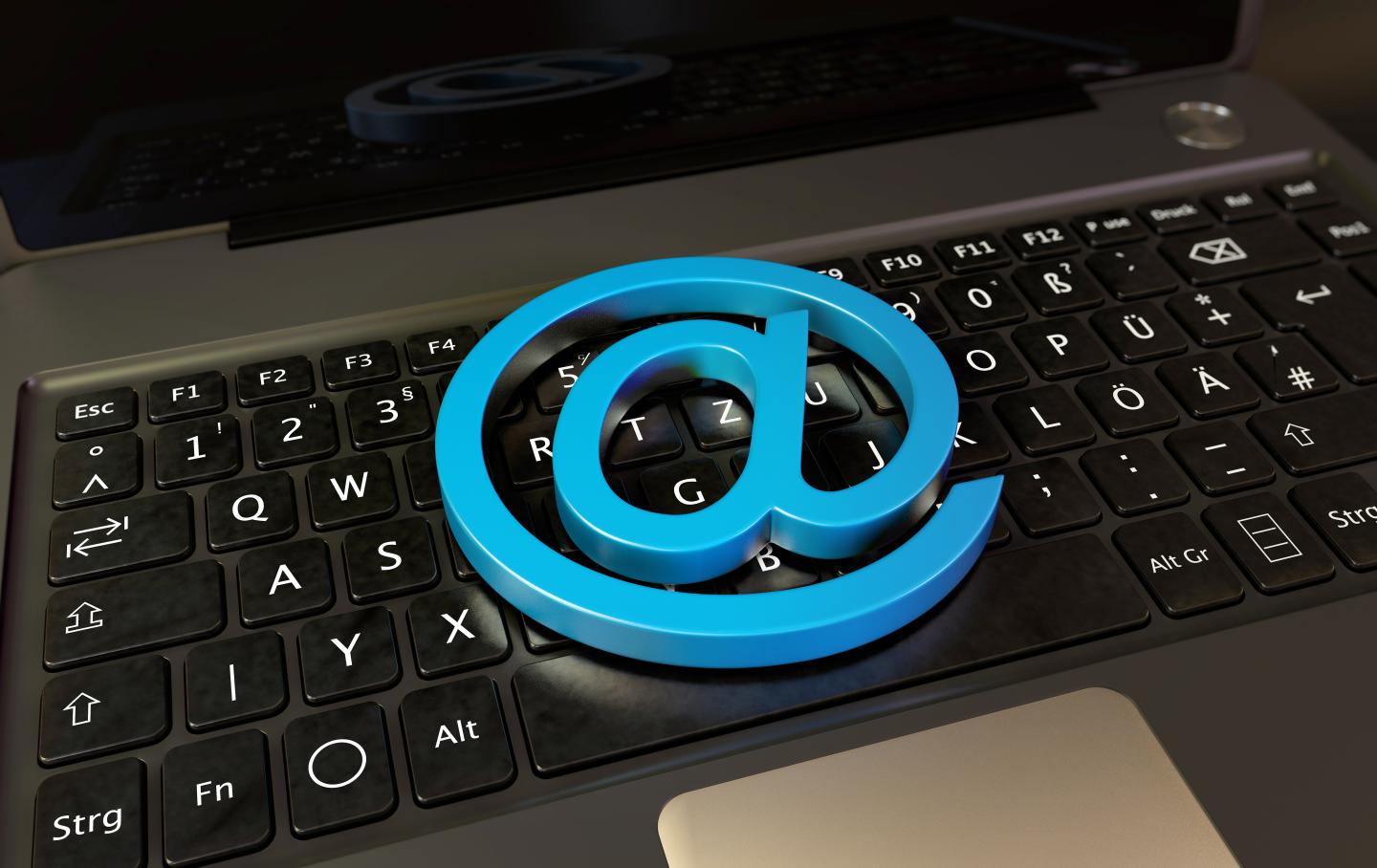 Blue at symbol on a laptop keyboard.