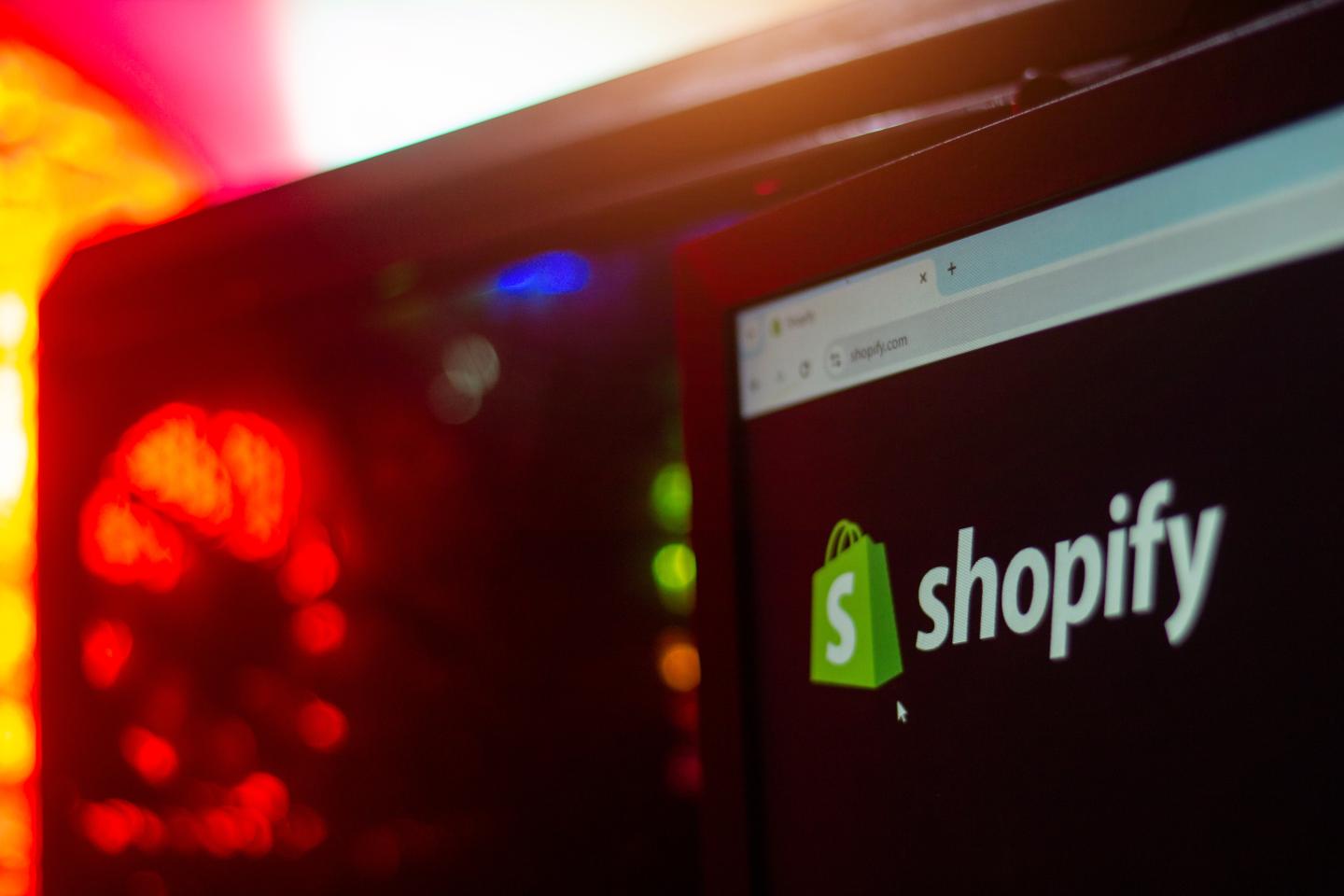 Shopify logo on a computer screen with colorful lights.