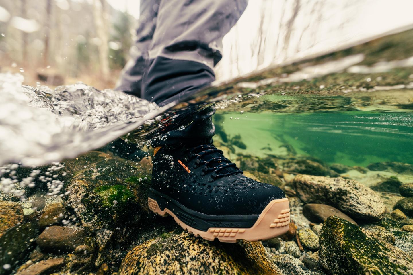 Wading boot submerged in a clear, flowing stream.