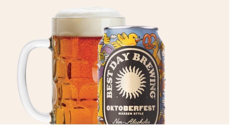 Beer mug filled with beer next to an illustrated beer can.